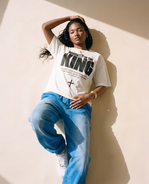 Daughter of the King MONOCHROME tee, white, woman, front print full body leaning against the wall