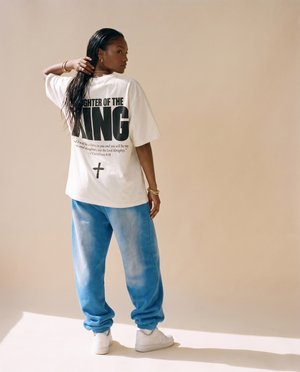 Daughter of the King MONOCHROME tee, white, back print edition, woman, back print full body with hand on the braid