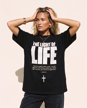 The Light of Life MONOCHROME tee, black, front print, woman, hands behind head