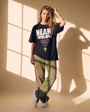 Heart Wide Open tee, black, front print, woman, full body hand in hair