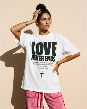 Love Never Ends tee, white, front print, woman, hand in hair thigh up