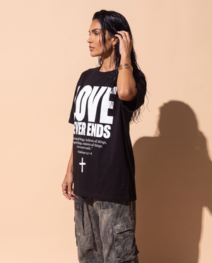 Love Never Ends tee, black, front print, woman, side profile thigh up