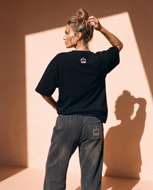 Light Over Darkness tee, black, back print, woman, back view hand in hair