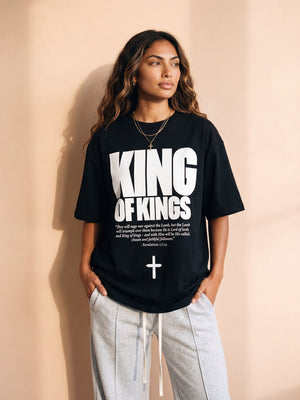 King of Kings tee, black, front print, woman, hands in pockets thigh up