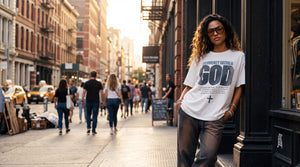 Woman in Heavenly Father God tee on a SoHo sidewalk at golden hour