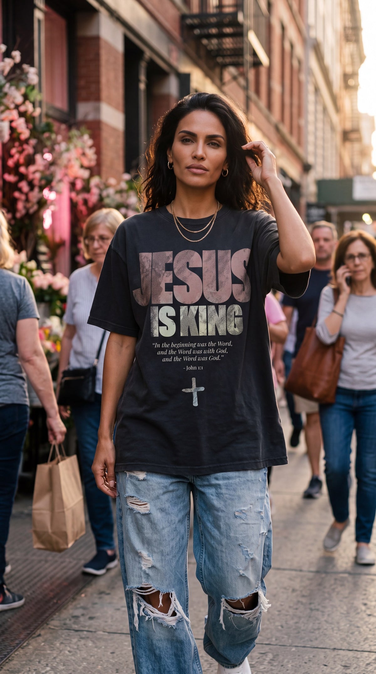 Woman in The Word Jesus Is King tee in front of a flower shop