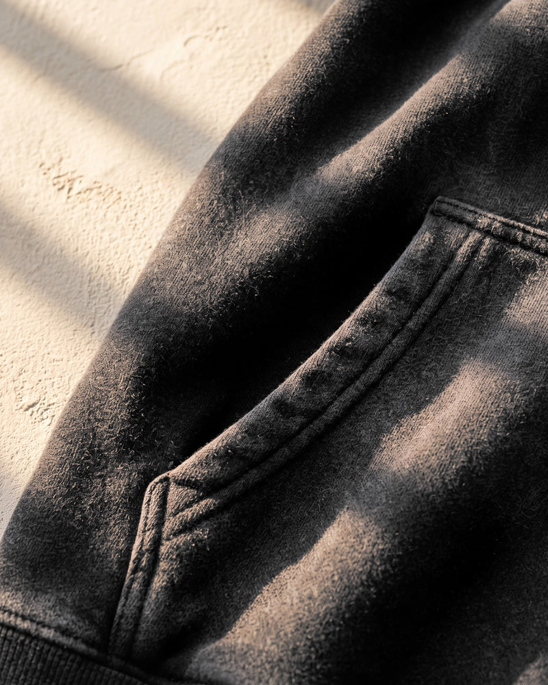 Black faded hoodie, kangaroo pocket, close-up