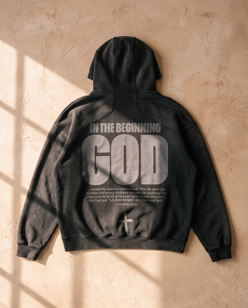 Black faded hoodie laid flat, In The Beginning God print on the back