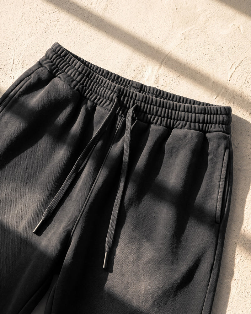 Elastic waistband with drawcord and black aglets on black The Word sweatpants