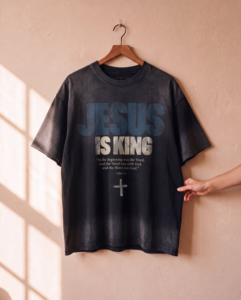 Jesus Is King faded black tee on a hanger, front print