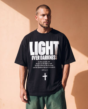 Light Over Darkness tee, black, front print, man, standing thigh up