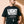 Light Over Darkness tee, black, front print, man, hand on hem thigh up