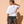 Light Over Darkness tee, white, back print, woman, back view look over