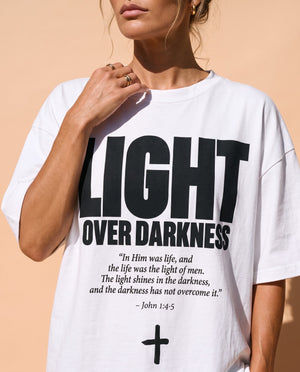 Light Over Darkness tee, white, front print, woman, chest close up
