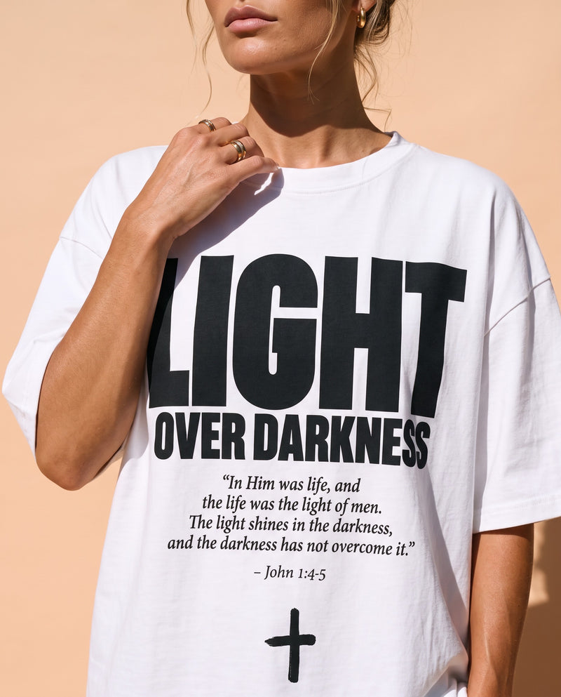 Light Over Darkness tee, white, front print, woman, chest close up